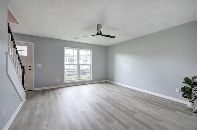 128 Evergreen Trl Unit 4, Cartersville, GA 30121 - empty room featuring wood finished floors, a textured ceiling, a ceiling fan, baseboards, and stairs