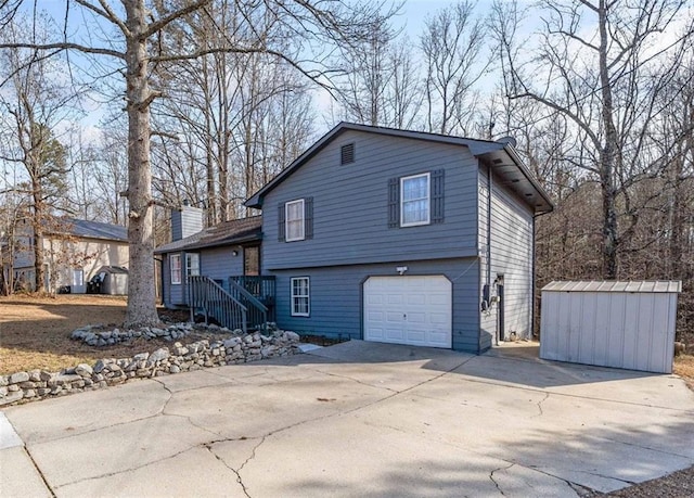 view of front of house with a storage shed and a garage