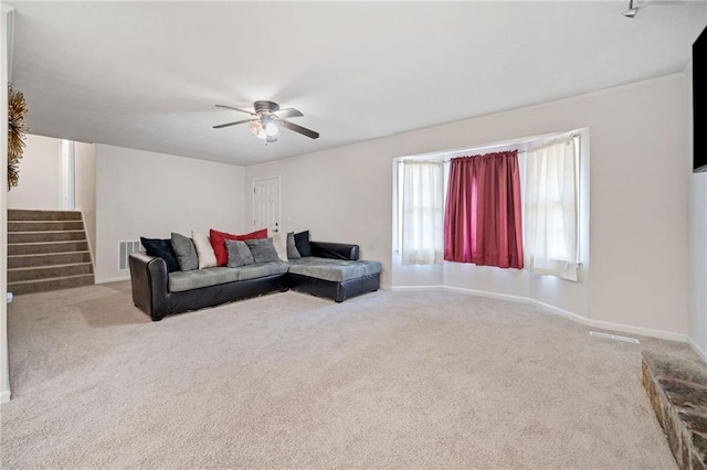 carpeted living room featuring ceiling fan