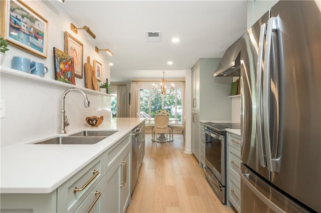 39 Ivy Gates NE, Atlanta, GA 30342 - kitchen with light countertops, visible vents, appliances with stainless steel finishes, light wood finished floors, and a sink