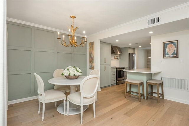 39 Ivy Gates NE, Atlanta, GA 30342 - dining space featuring light wood-style floors, a decorative wall, a notable chandelier, and visible vents