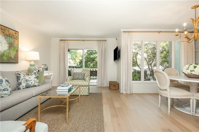 39 Ivy Gates NE, Atlanta, GA 30342 - living room with light wood-style flooring, crown molding, a notable chandelier, and a wealth of natural light