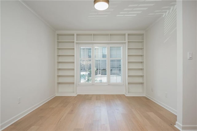 39 Ivy Gates NE, Atlanta, GA 30342 - spare room featuring light wood-type flooring, baseboards, ornamental molding, and built in shelves