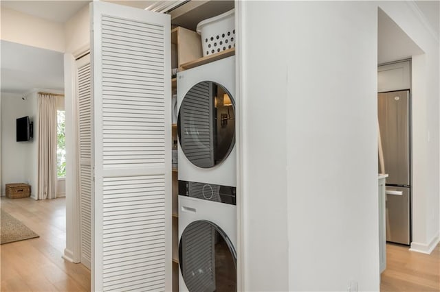 39 Ivy Gates NE, Atlanta, GA 30342 - laundry room featuring laundry area, crown molding, light wood-type flooring, and stacked washer / drying machine
