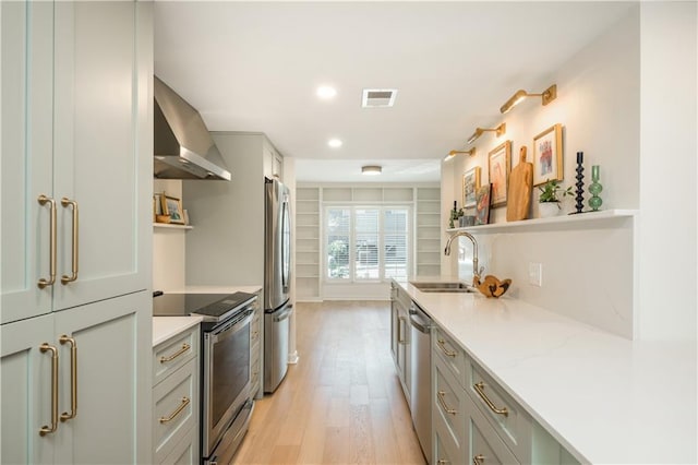 39 Ivy Gates NE, Atlanta, GA 30342 - kitchen featuring open shelves, wall chimney exhaust hood, stainless steel appliances, light wood finished floors, and a sink