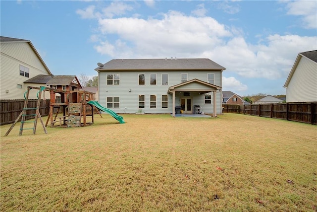 back of property featuring a yard, a playground, and a patio