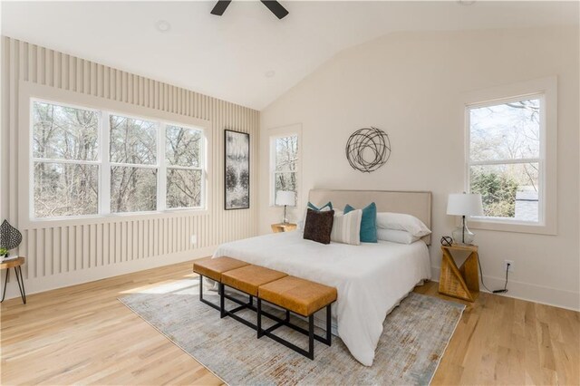 bedroom featuring vaulted ceiling, wood finished floors, a ceiling fan, and baseboards