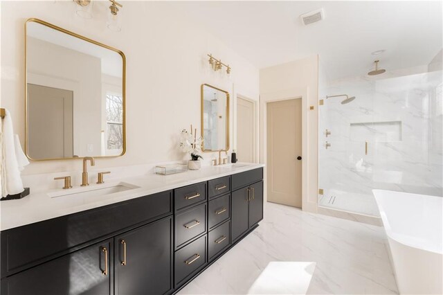 bathroom featuring marble finish floor, a marble finish shower, visible vents, and a sink