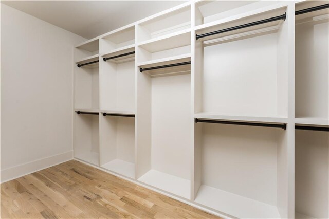 walk in closet featuring light wood-style flooring