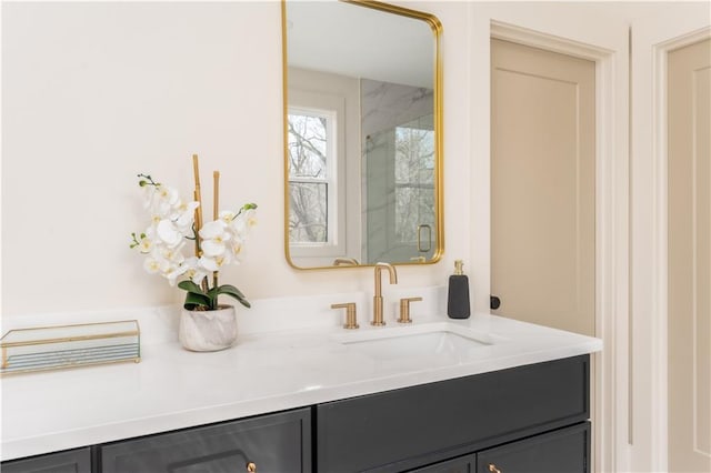 bathroom featuring a marble finish shower and vanity