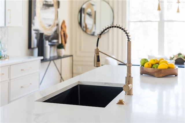 details featuring white cabinets and a sink