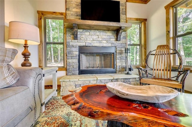 sitting room with plenty of natural light and a fireplace