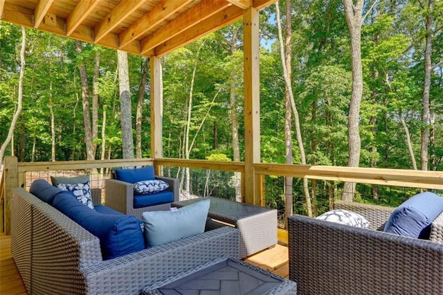 sunroom / solarium featuring a wooded view