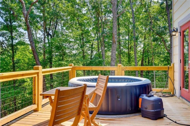 wooden terrace featuring a hot tub