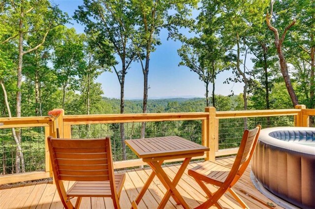 wooden deck featuring a view of trees