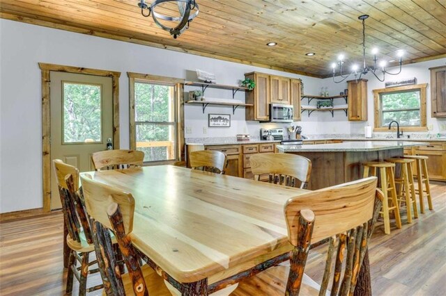 dining room with baseboards, light wood finished floors, wooden ceiling, and recessed lighting