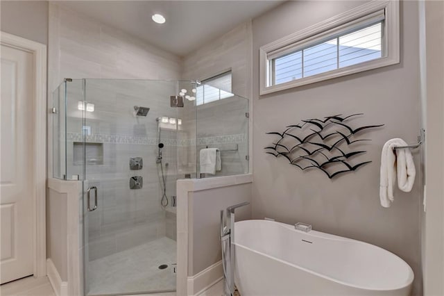 bathroom featuring a shower stall, recessed lighting, and a freestanding bath