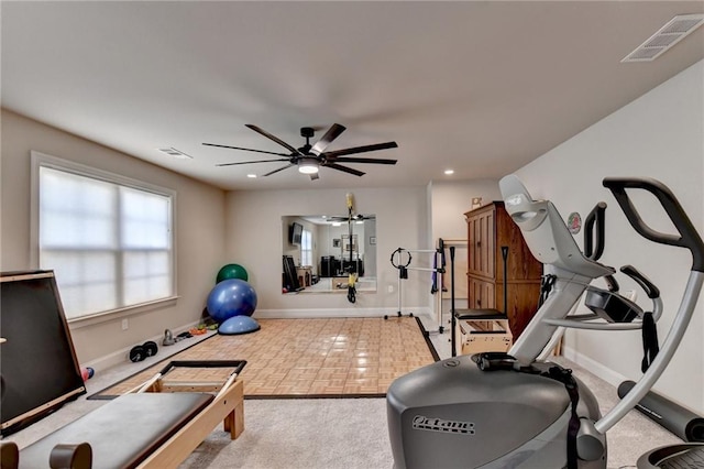 workout area featuring baseboards, visible vents, recessed lighting, and ceiling fan