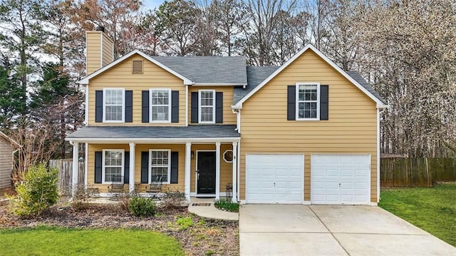 traditional-style house featuring driveway, a garage, a chimney, fence, and a porch