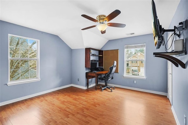 office space with light wood finished floors, visible vents, and baseboards