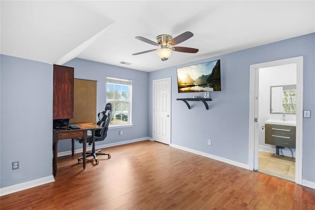 home office featuring visible vents, baseboards, and wood finished floors