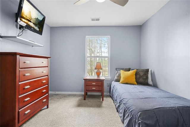 bedroom featuring light carpet, ceiling fan, visible vents, and baseboards