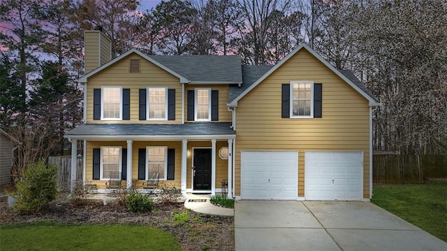 traditional-style house featuring covered porch, concrete driveway, fence, and a garage