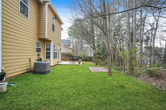 view of yard featuring central AC, fence, and a patio