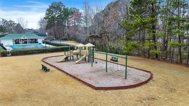 communal playground with a lawn and a community pool