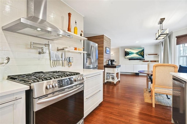 kitchen featuring appliances with stainless steel finishes, wine cooler, light countertops, and wall chimney range hood