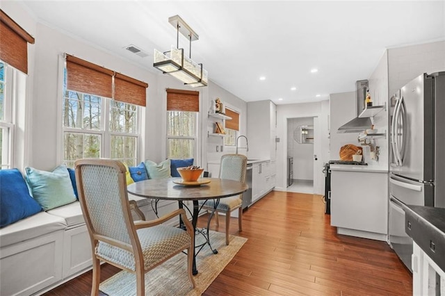 dining area with recessed lighting, visible vents, and wood finished floors