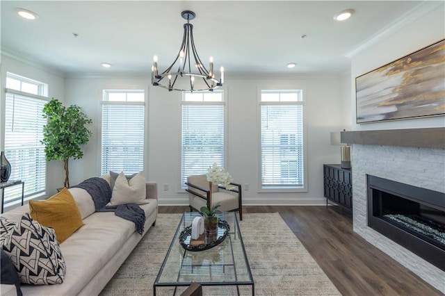 living room featuring a healthy amount of sunlight, a stone fireplace, and dark wood-type flooring