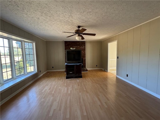 unfurnished living room with wood-type flooring, a textured ceiling, and ceiling fan