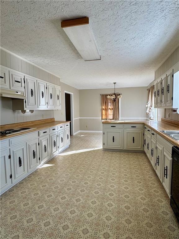 kitchen with hanging light fixtures, gas cooktop, a chandelier, a textured ceiling, and white cabinets