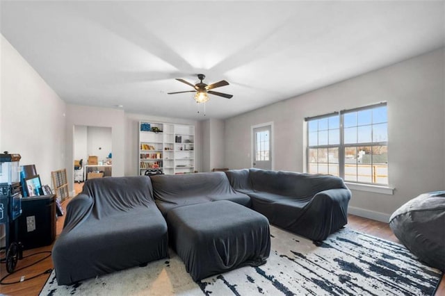 living room with ceiling fan and light wood-type flooring