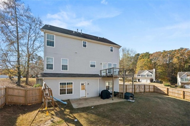 back of property with a yard and a patio area