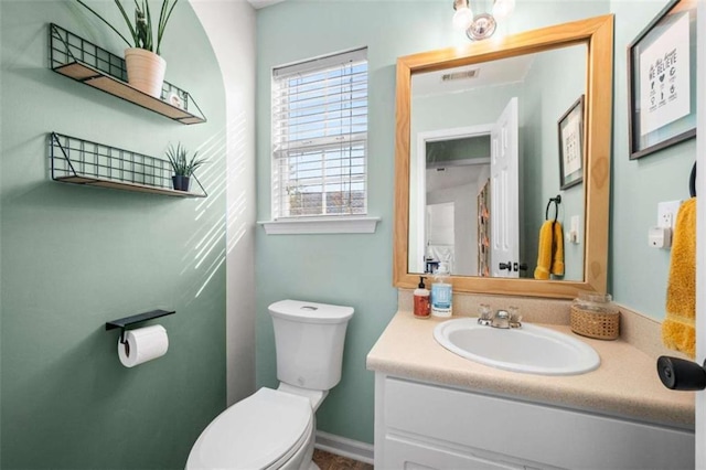 bathroom featuring vanity and toilet