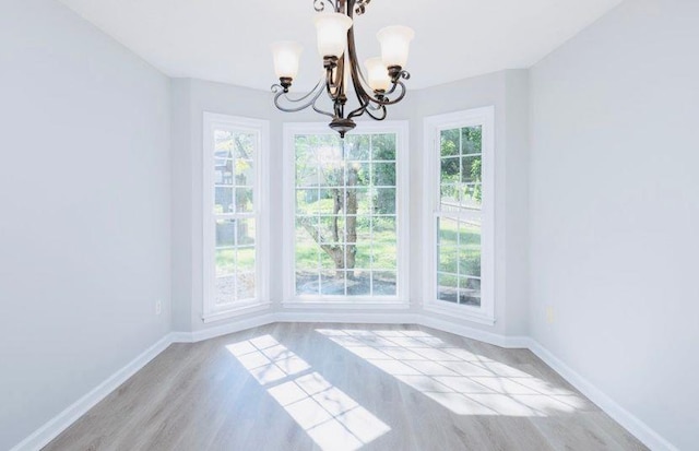 1391 Warrenton Hunt, Lawrenceville, GA 30043 - unfurnished dining area with a chandelier and wood finished floors