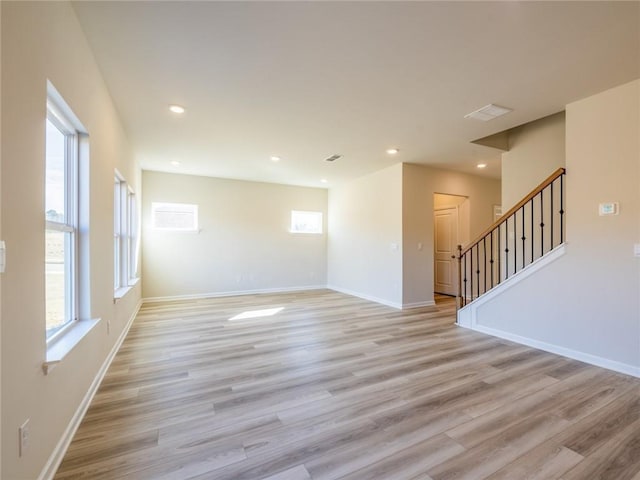 spare room featuring light wood-type flooring and a wealth of natural light