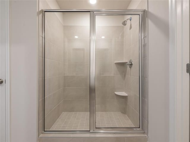 bathroom with a shower with shower door