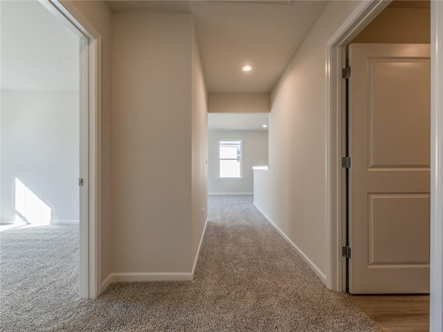 hallway featuring light carpet