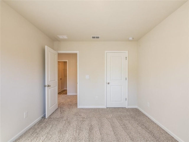 unfurnished bedroom with light colored carpet