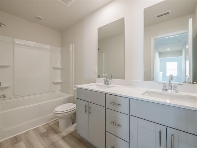 full bathroom with toilet, vanity, shower / bathtub combination, and hardwood / wood-style flooring