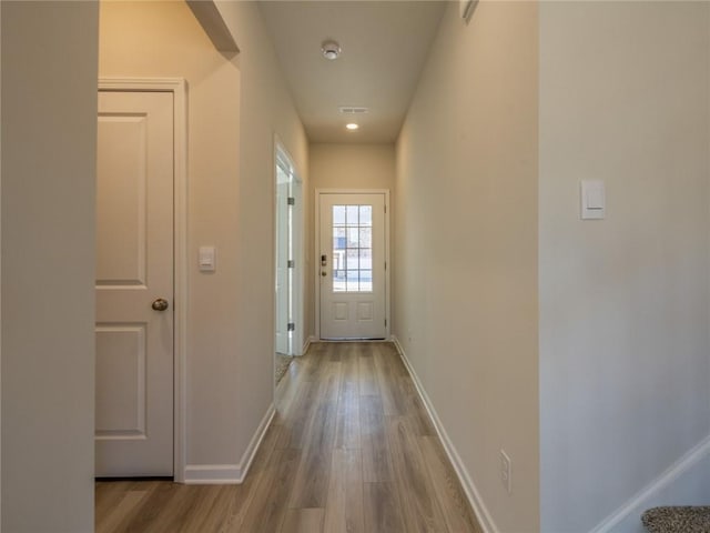 corridor with light hardwood / wood-style flooring