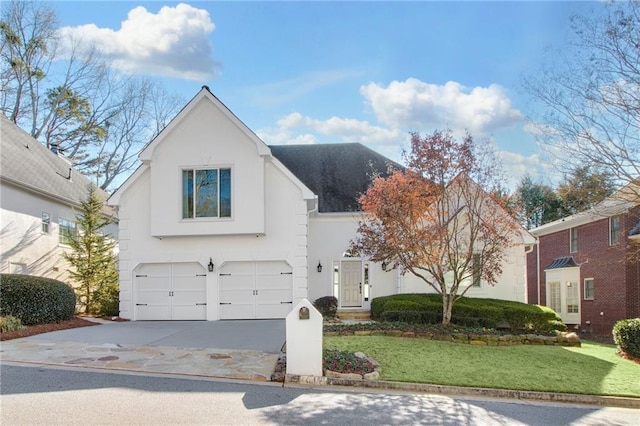 front facade with a garage and a front lawn