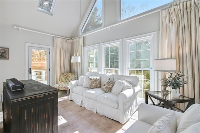 living room featuring high vaulted ceiling and light tile patterned flooring