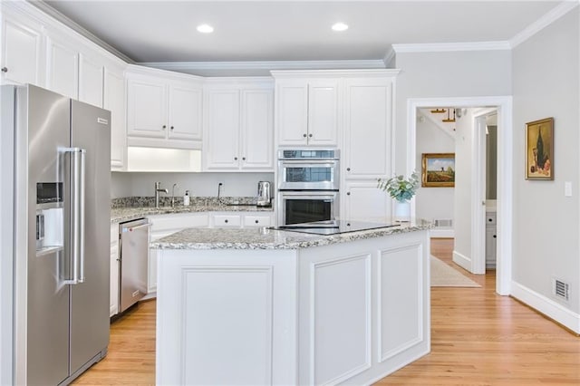 kitchen with white cabinetry, a center island, and stainless steel appliances