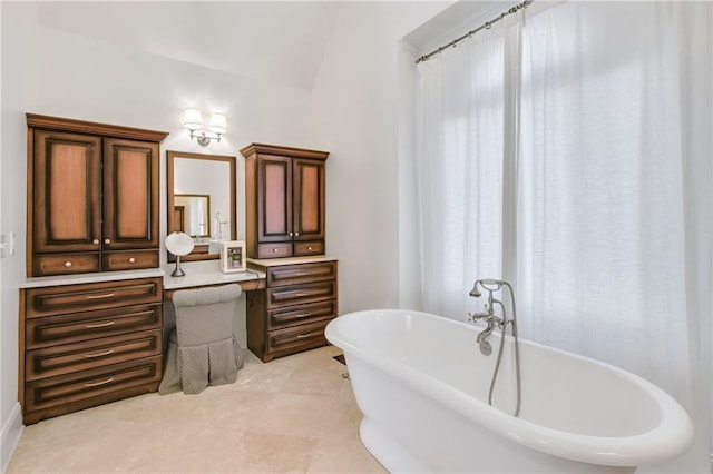 bathroom featuring vaulted ceiling and a bathtub