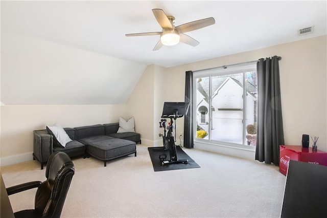 exercise room with ceiling fan, light carpet, and vaulted ceiling