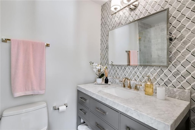 bathroom featuring toilet and vanity